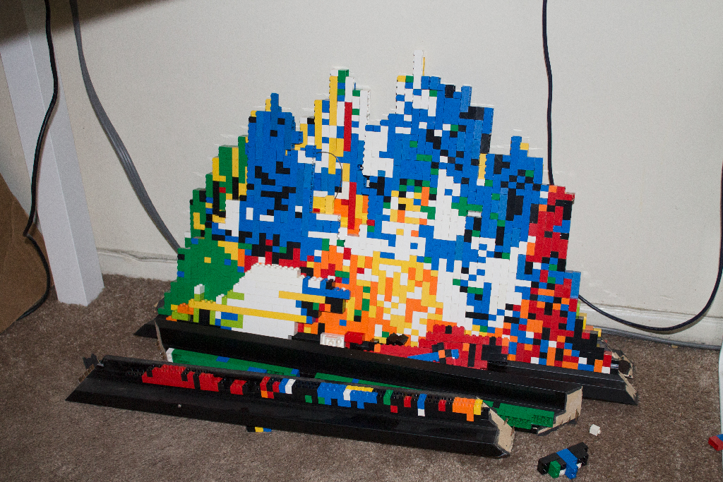 Broken LEGO brick on the floor leaning against a wall